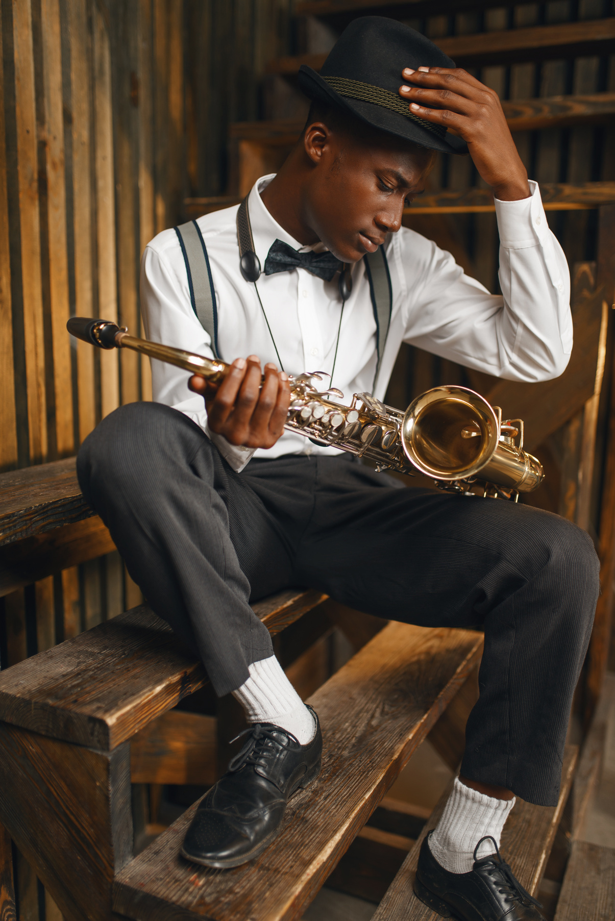 Black Jazz Musician Sitting with Saxophone